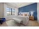 Spacious bedroom with a king-size bed and blue accent wall at 4943 Ribbon Rock Cv, Lakewood Ranch, FL 34211