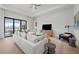 Comfortable living room with sectional sofa and access to patio at 4943 Ribbon Rock Cv, Lakewood Ranch, FL 34211