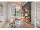 Home office with built-in shelving and wood-like flooring at 4943 Ribbon Rock Cv, Lakewood Ranch, FL 34211