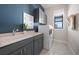 Laundry room with washer, dryer, and ample counter space at 4943 Ribbon Rock Cv, Lakewood Ranch, FL 34211