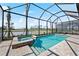 Resort-style pool and spa with screened enclosure and lake view at 4943 Ribbon Rock Cv, Lakewood Ranch, FL 34211