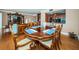 Bright dining room with hardwood floors, round table and chairs, and view to living room at 9 Turner St # 14, Clearwater, FL 33756