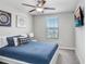 Bedroom with queen bed, window, and TV at 16764 Delia St, Wimauma, FL 33598