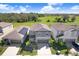 Aerial view of a two-story house with a gray exterior at 16764 Delia St, Wimauma, FL 33598