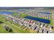 Aerial view of house, neighborhood, and lake at 16764 Delia St, Wimauma, FL 33598