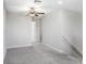 Spacious loft area with neutral carpeting and ceiling fan at 16764 Delia St, Wimauma, FL 33598