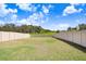 Large grassy backyard with a privacy fence at 16764 Delia St, Wimauma, FL 33598