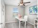 Bright bedroom with carpeted floor, desk, and window at 16764 Delia St, Wimauma, FL 33598