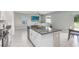 Open concept kitchen with island and view of living room at 16764 Delia St, Wimauma, FL 33598