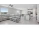 Open concept living room with sectional sofa and kitchen view at 16764 Delia St, Wimauma, FL 33598