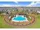 Resort-style community pool with lounge chairs and playground at 16764 Delia St, Wimauma, FL 33598