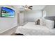 King-size bed, mounted TV, and neutral color palette at 16764 Delia St, Wimauma, FL 33598
