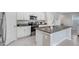 Modern kitchen with island and granite countertops at 16764 Delia St, Wimauma, FL 33598