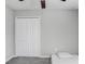 Bedroom with double doors and gray carpeting at 16764 Delia St, Wimauma, FL 33598