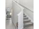 Modern staircase with carpeted steps and neutral color palette at 16764 Delia St, Wimauma, FL 33598