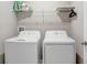 Laundry room with washer, dryer, and shelving at 16764 Delia St, Wimauma, FL 33598