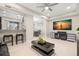Open living area with a black leather sectional sofa, coffee table, and adjacent kitchen at 5018 Sunnyside Ln, Bradenton, FL 34211
