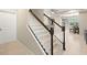 Clean, modern interior staircase with dark wood railings at 5018 Sunnyside Ln, Bradenton, FL 34211