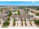 Aerial view of a townhome community showing the subject property, a lake, and surrounding homes at 5018 Sunnyside Ln, Bradenton, FL 34211