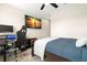 Bedroom with a workspace and large TV at 5018 Sunnyside Ln, Bradenton, FL 34211