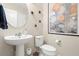 Clean and modern bathroom with pedestal sink and art at 5018 Sunnyside Ln, Bradenton, FL 34211