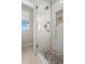 Modern bathroom with a glass shower door and pebble floor at 5018 Sunnyside Ln, Bradenton, FL 34211