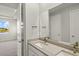 Modern bathroom with dual sinks, a large mirror, and a view into a bedroom at 11269 Boundless Ter, Venice, FL 34293
