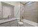Clean bathroom with a single sink, tub, and modern gray tile at 11269 Boundless Ter, Venice, FL 34293