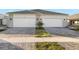 Two-story home with gray stone accents and a two-car garage at 11269 Boundless Ter, Venice, FL 34293