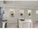 Modern kitchen with white cabinets, stainless steel appliances, and an island at 11269 Boundless Ter, Venice, FL 34293