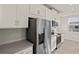 Modern kitchen with white cabinets and stainless steel appliances at 11269 Boundless Ter, Venice, FL 34293