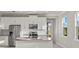 Modern kitchen with white cabinets, stainless steel appliances, and an island at 11269 Boundless Ter, Venice, FL 34293
