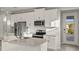Modern kitchen with white cabinets, stainless steel appliances, and an island at 11269 Boundless Ter, Venice, FL 34293