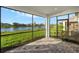 Relaxing screened porch overlooking a lake. Features paver patio and multiple windows at 11269 Boundless Ter, Venice, FL 34293