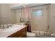 Clean bathroom with a tub shower combination and wood vanity at 5651 Wesson Rd, New Port Richey, FL 34655