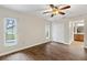 Bedroom features wood-look floors, dual windows, and a ceiling fan at 5651 Wesson Rd, New Port Richey, FL 34655