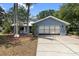 Inviting single-story home featuring a spacious driveway, well-kept lawn, and attached two car garage at 5651 Wesson Rd, New Port Richey, FL 34655