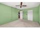 Light green-walled bedroom with ceiling fan and closet at 2747 Sand Hollow Ct, Clearwater, FL 33761