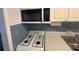 Kitchen details: microwave, gas cooktop, and sink at 5945 21St N St # 14, St Petersburg, FL 33714
