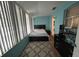 Bright bedroom with sunroom access and stylish furniture at 5945 21St N St # 14, St Petersburg, FL 33714