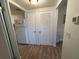 Clean hallway with light wood flooring and linen closet at 5945 21St N St # 14, St Petersburg, FL 33714
