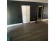 Living room with dark walls, laminate flooring, and a closet at 5122 Lillilea Ln, New Port Richey, FL 34653