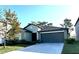 One-story home with a gray garage door and well-maintained lawn at 12907 Wildflower Meadow Dr, Riverview, FL 33579