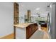 Spacious kitchen features granite countertops, stainless steel appliances, and breakfast bar overlooking the living room at 18593 Bridle Club Dr, Tampa, FL 33647
