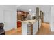 Open kitchen boasts granite countertops and stone accents with wooden cabinets and stainless appliances at 18593 Bridle Club Dr, Tampa, FL 33647