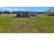Back of house with a large yard and a covered patio at 5302 Turkey Creek Rd, Plant City, FL 33567