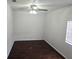 Bright bedroom features dark wood floors, a ceiling fan and natural light at 5302 Turkey Creek Rd, Plant City, FL 33567