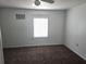 Bright Bedroom features neutral carpeting, a ceiling fan, and natural light at 5302 Turkey Creek Rd, Plant City, FL 33567