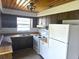 This kitchen features wood cabinets, stainless steel sink, stove, oven and a white refrigerator at 5302 Turkey Creek Rd, Plant City, FL 33567