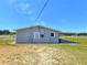 View of the home's rear showcasing a covered patio and spacious yard at 5302 Turkey Creek Rd, Plant City, FL 33567